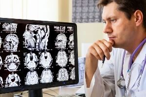 Physician looking on a brain injury patient examination