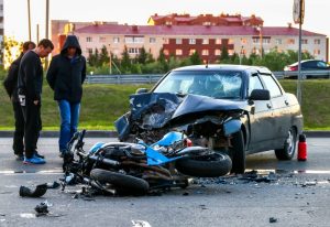 A motorcycle and car collision scene.