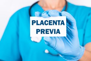 An OB holding a signage showing placenta previa.