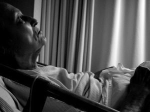 Elderly man in hospital bed