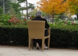 elderly person sitting outside