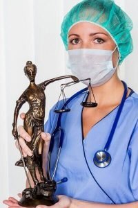 Nurse Holding Statue of Lady Justice