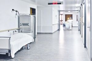 hospital bed and other equipment in an empty hospital hallway