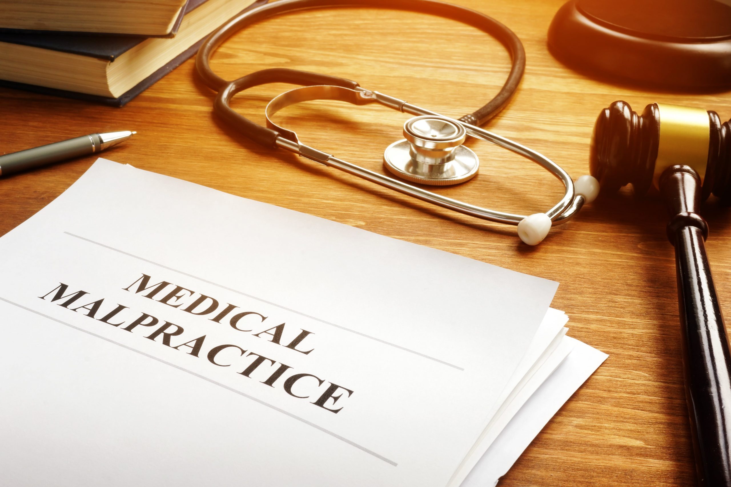 Medical malpractice report documents and the stethoscope.