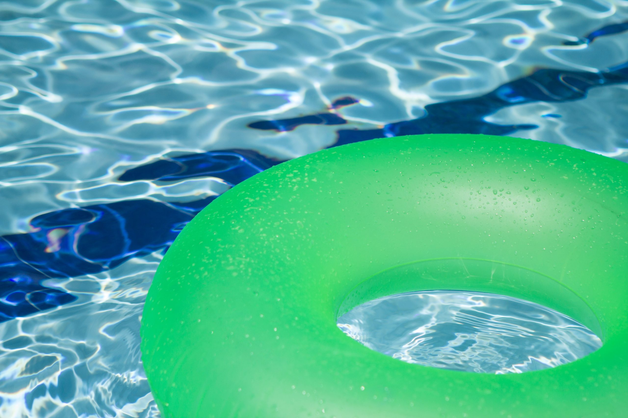 Green inflatable floatie in pool